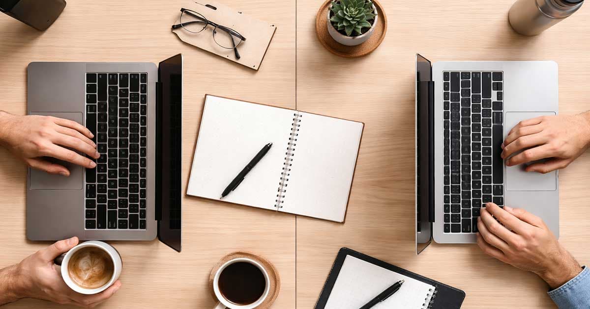 2 people sharing a desk